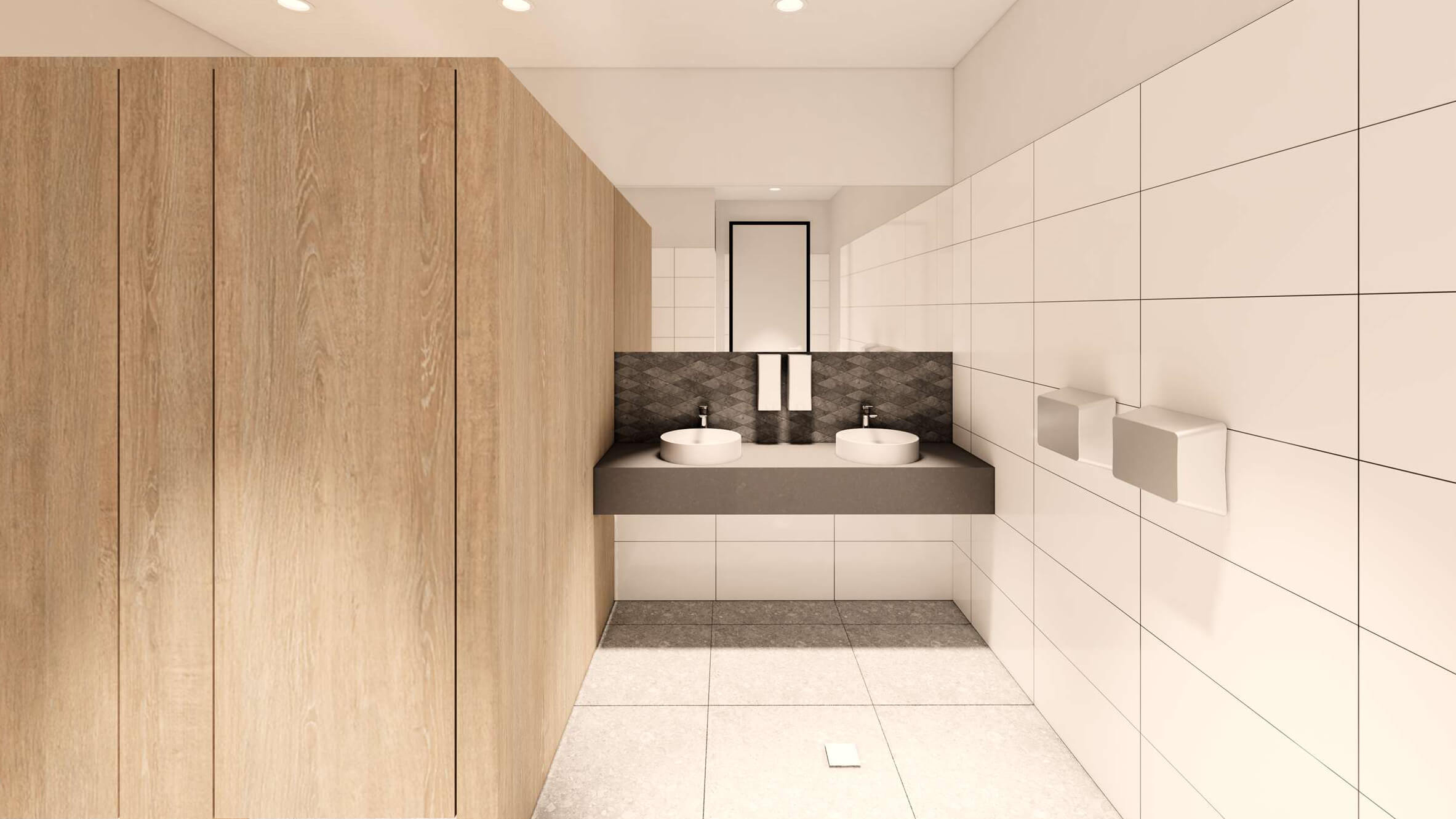 Modern bathroom with double round sinks on a floating gray countertop, wooden cabinets, white tiled walls, and a large mirror.